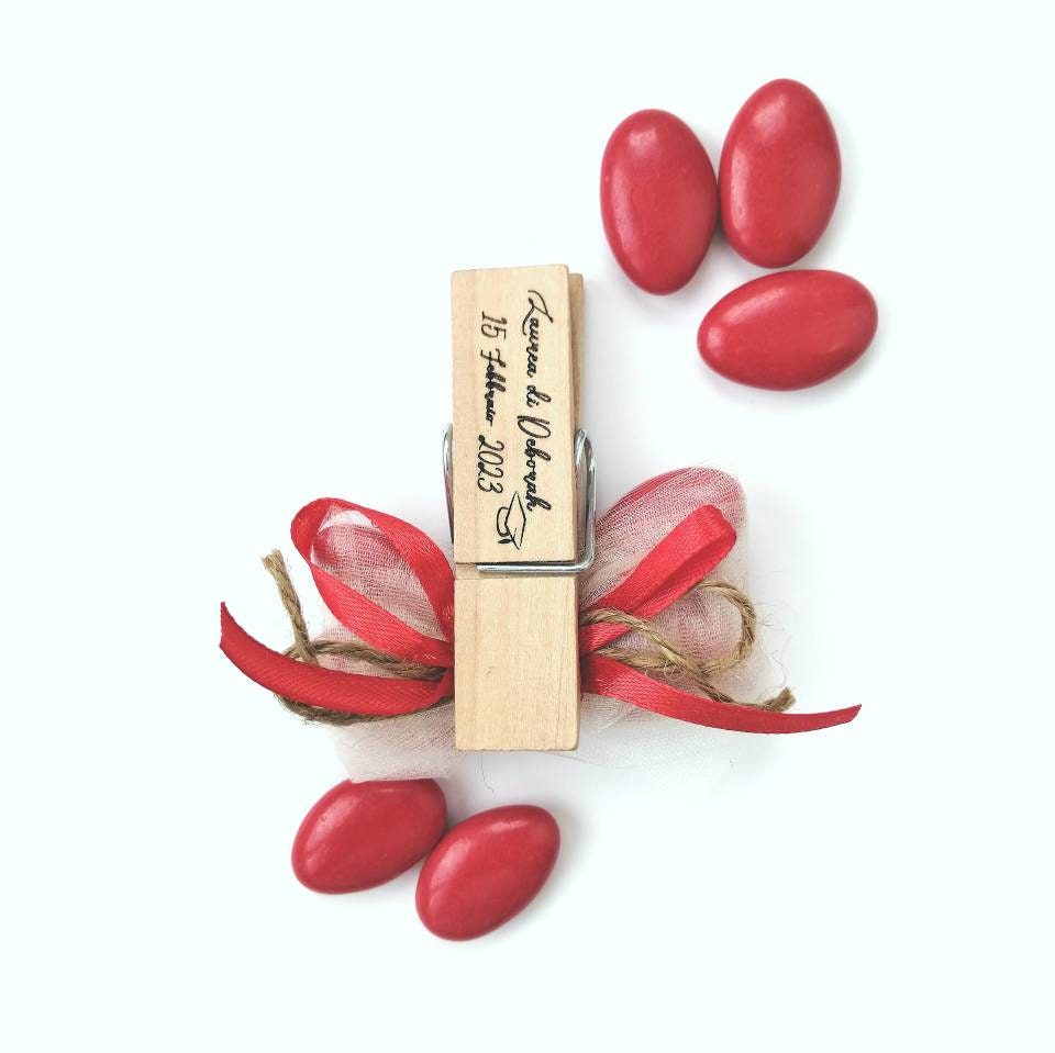 Graduation favor handcrafted wooden clothespin with personalized engraving wrapped in red graduated sugared almonds