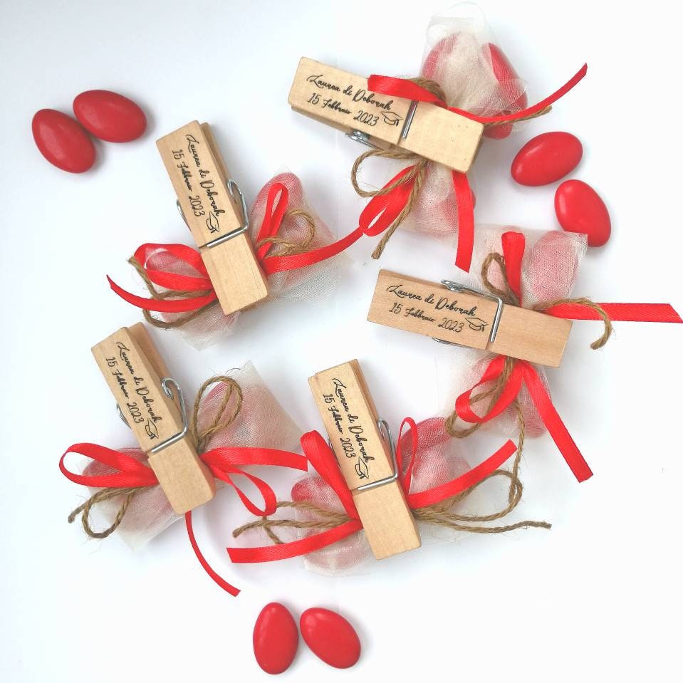 Graduation favor handcrafted wooden clothespin with personalized engraving wrapped in red graduated sugared almonds