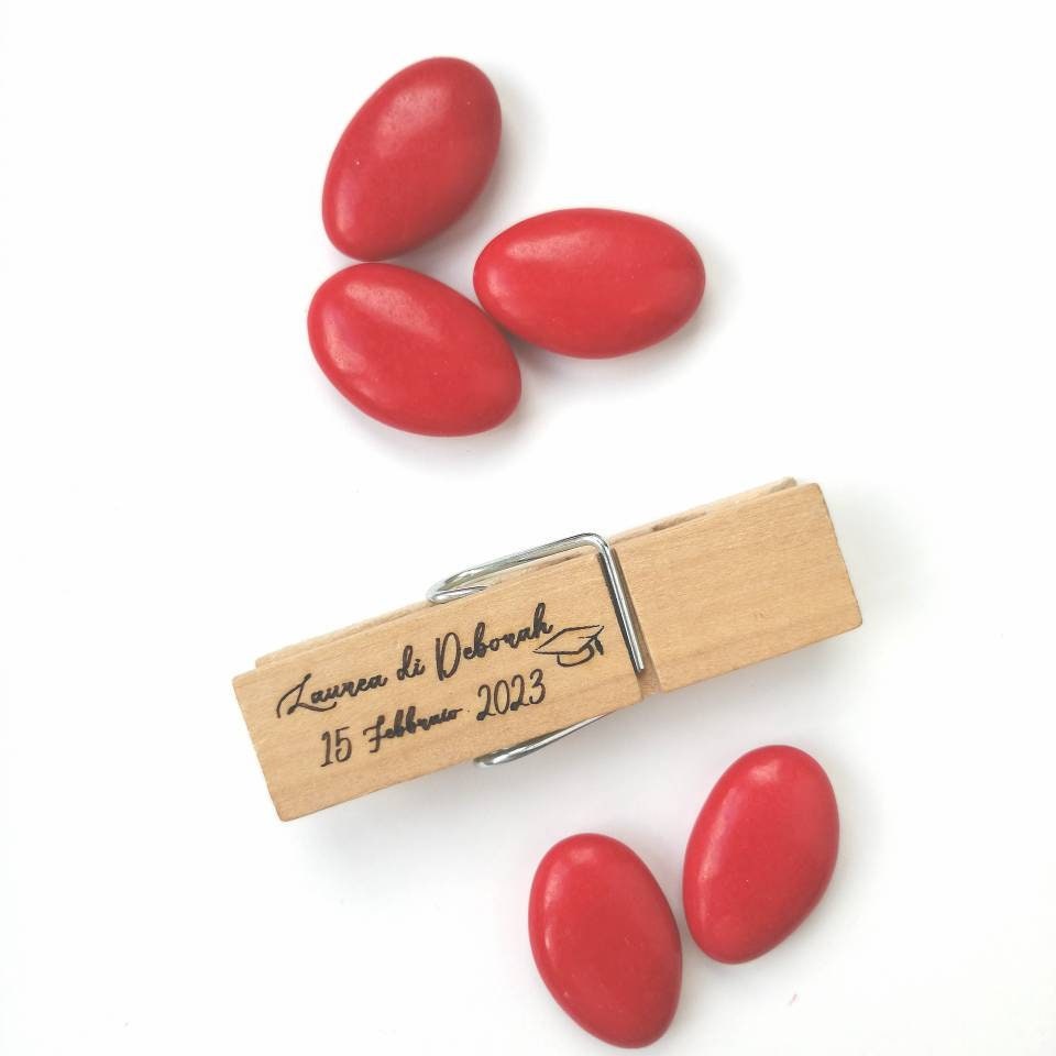 Graduation favor handcrafted wooden clothespin with personalized engraving wrapped in red graduated sugared almonds